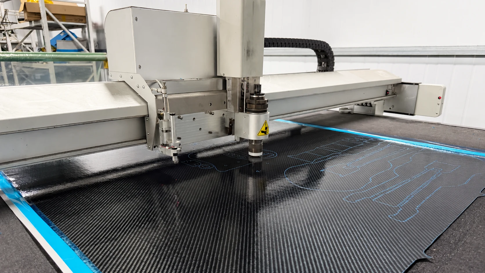 CNC machine cutting component profiles from a carbon fiber sheet