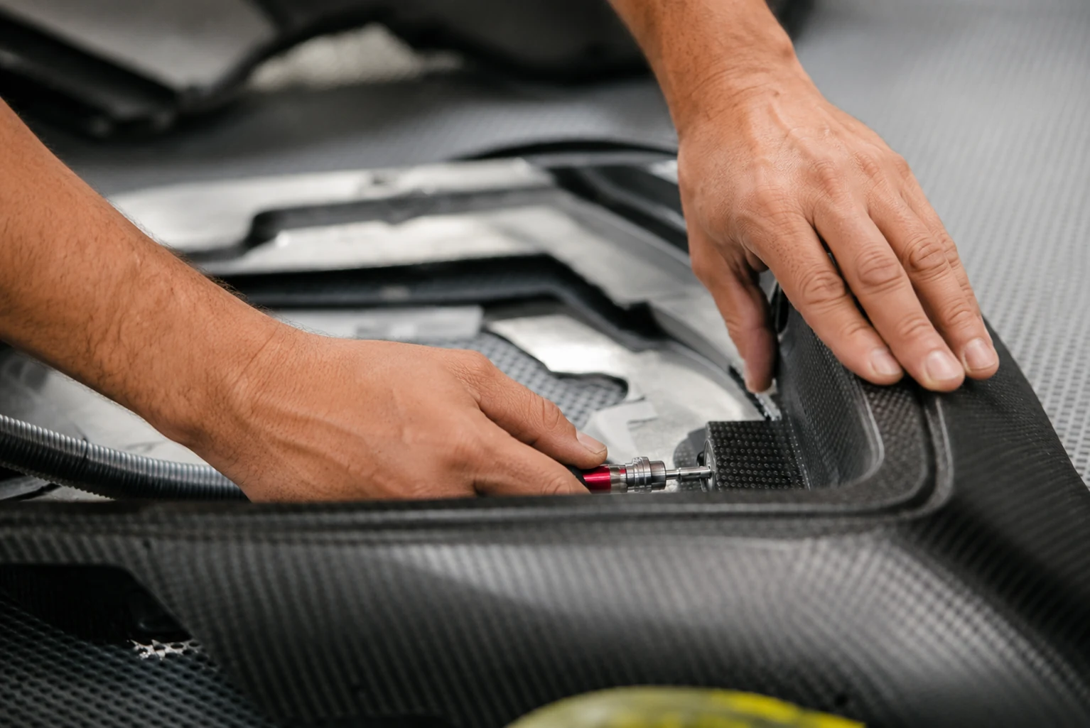 Technician forming carbon fiber material in a production mold