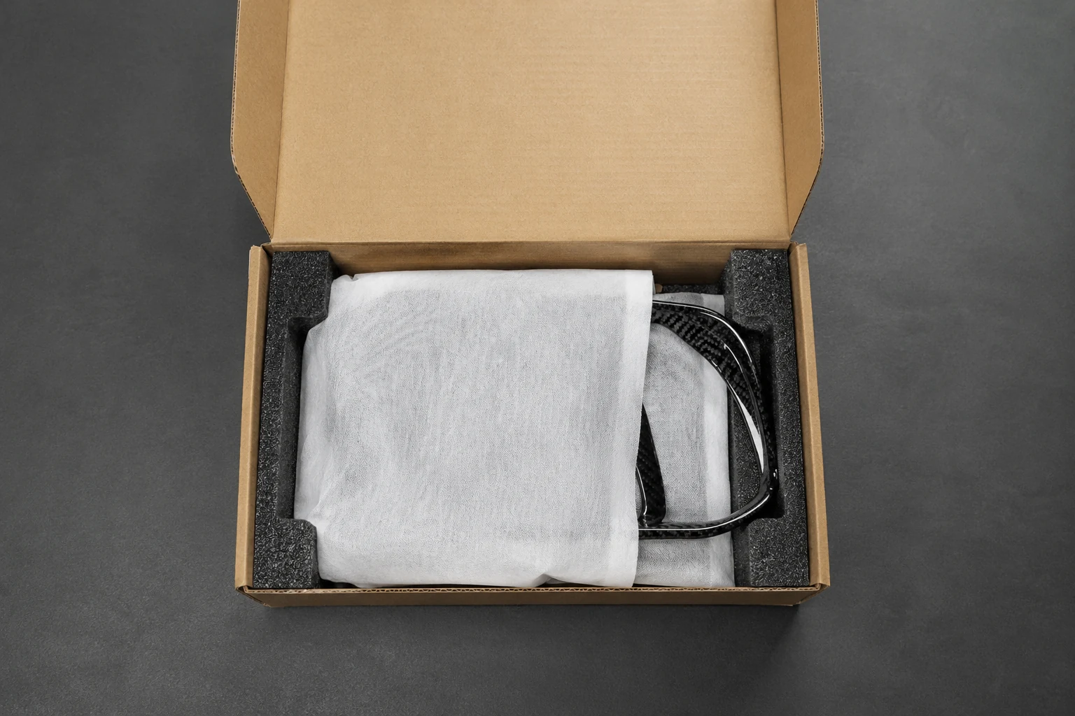 Carbon fiber parts protected with sleeves and custom foam inside a shipping box