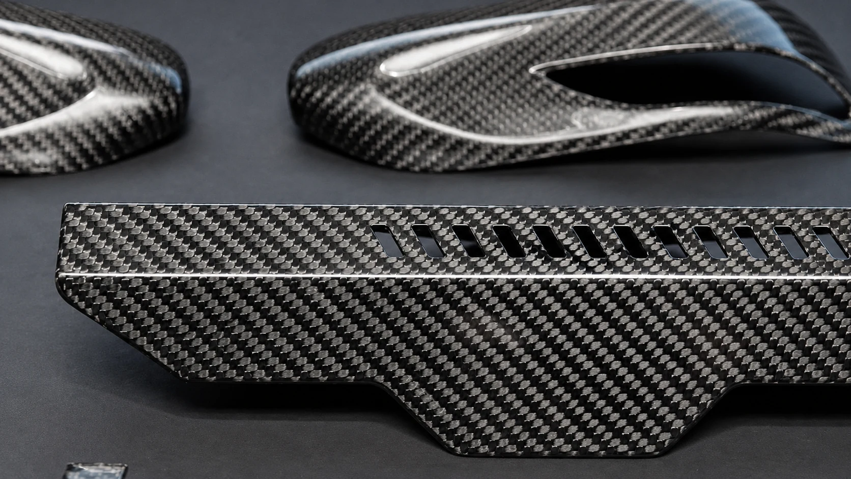 Custom carbon fiber components with machined openings and woven finish