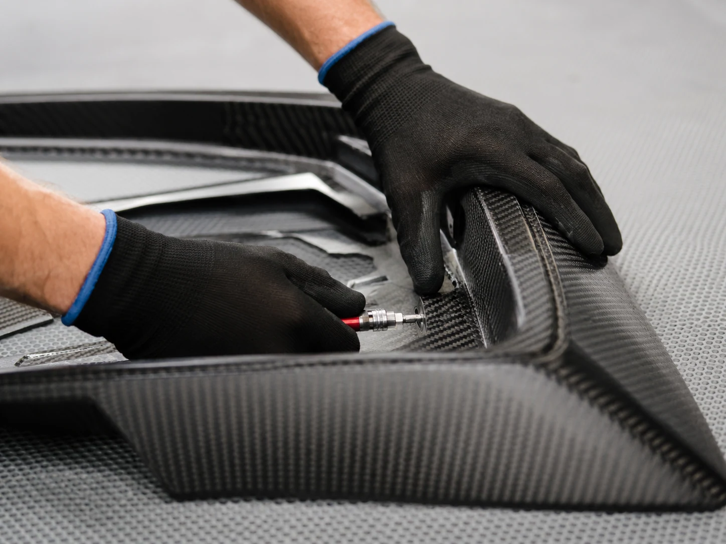 Carbon fiber appearance sample checked for weave and surface finish