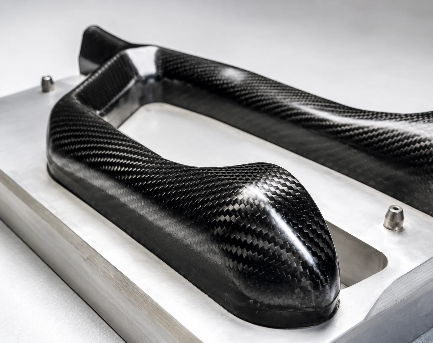 Molded carbon fiber housing positioned in a metal fixture