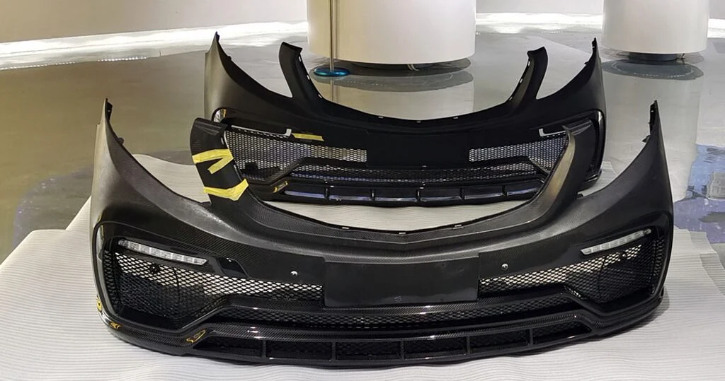 Carbon fiber automotive bumper components arranged as a production set