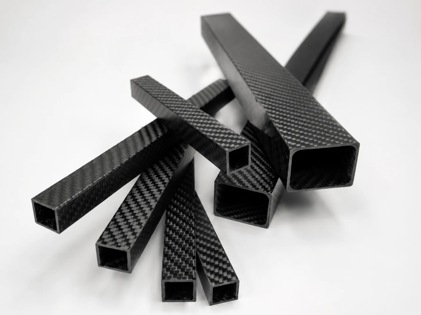 Square and rectangular hollow carbon fiber profiles with visible section ends