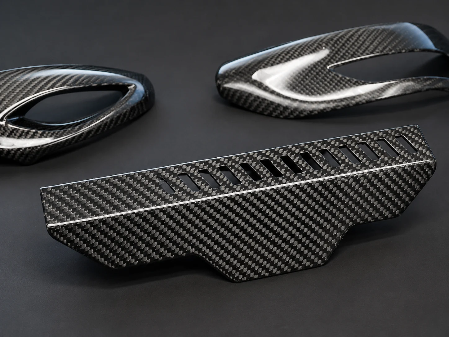 Assorted finished carbon fiber components for project review