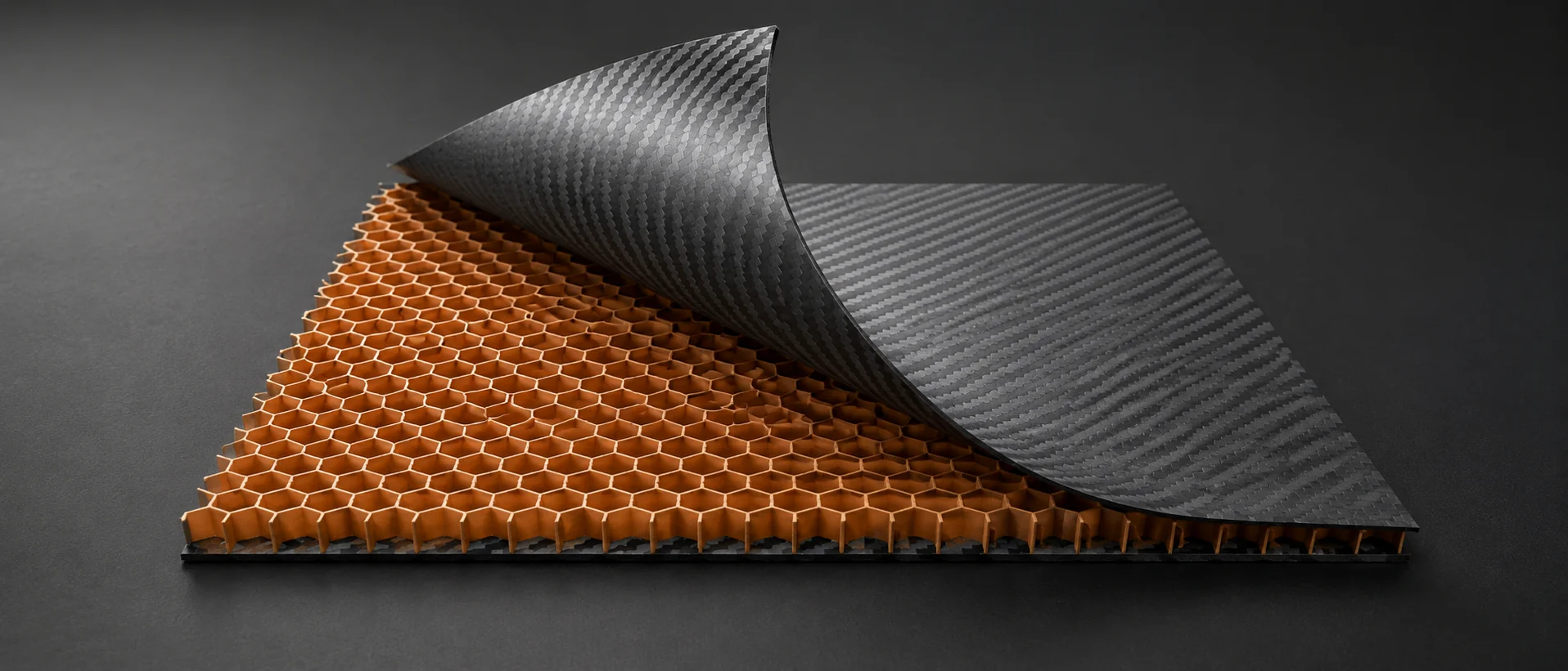 Carbon fiber sandwich construction with a honeycomb core and separated woven skins
