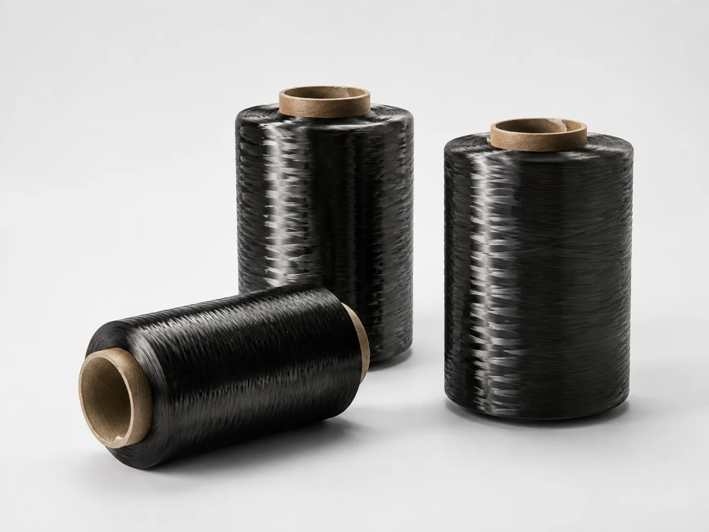Carbon fiber tow wound on three industrial packages
