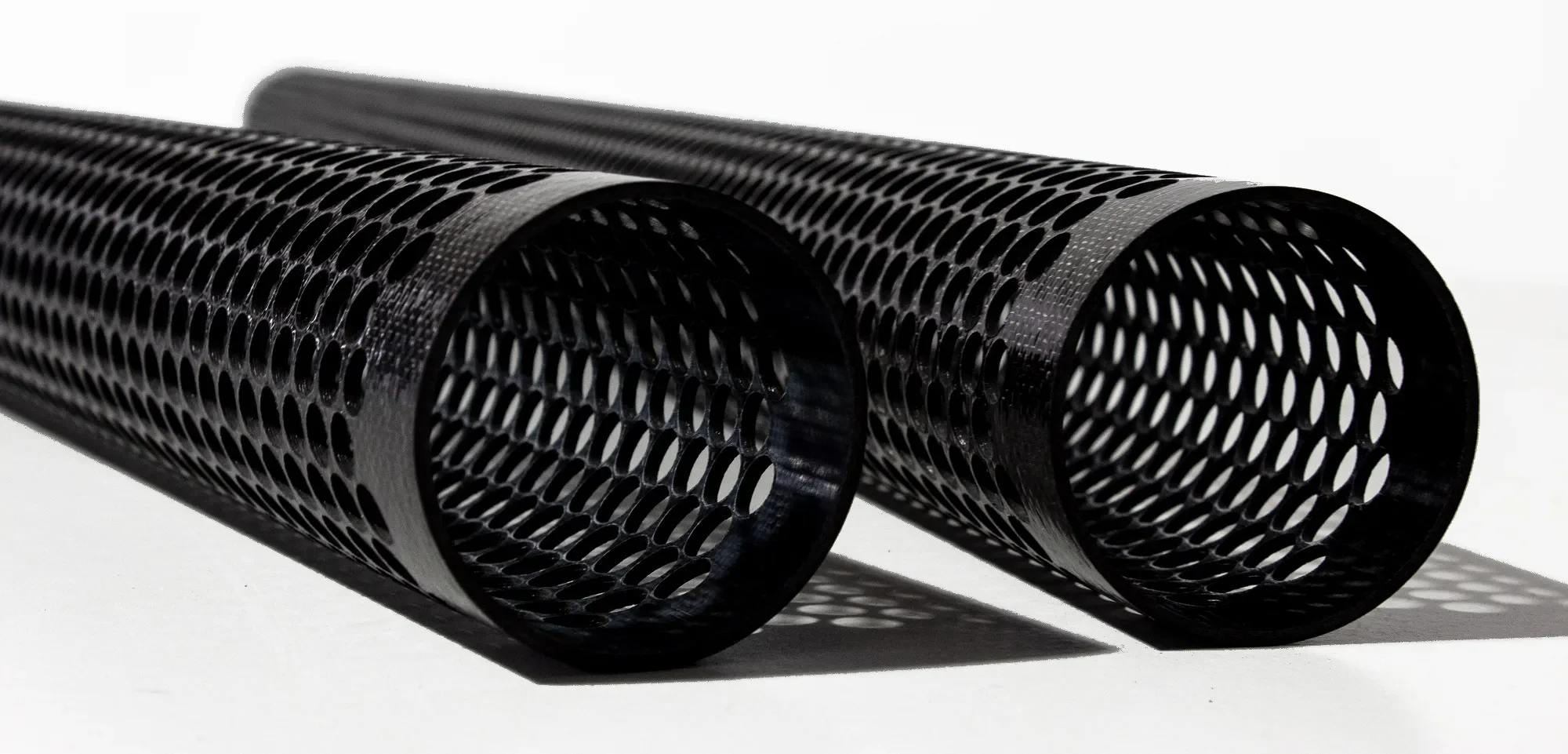Perforated carbon fiber tubes showing distinct profile and finished-object levels