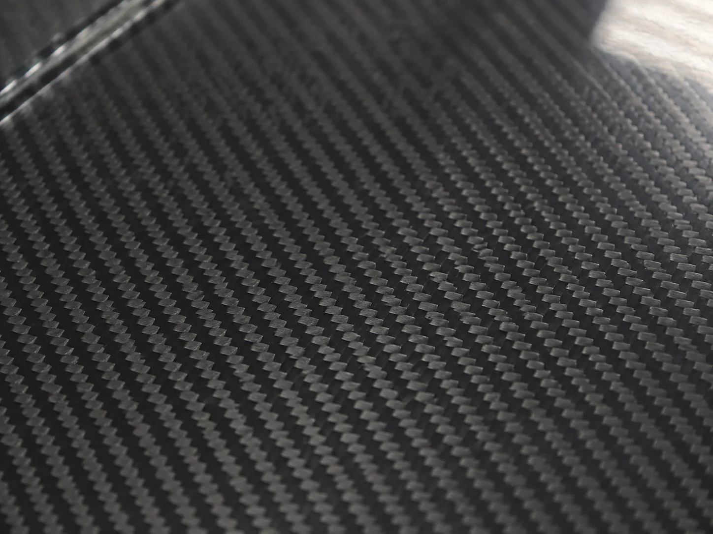 Close view of a visible twill carbon fiber weave pattern