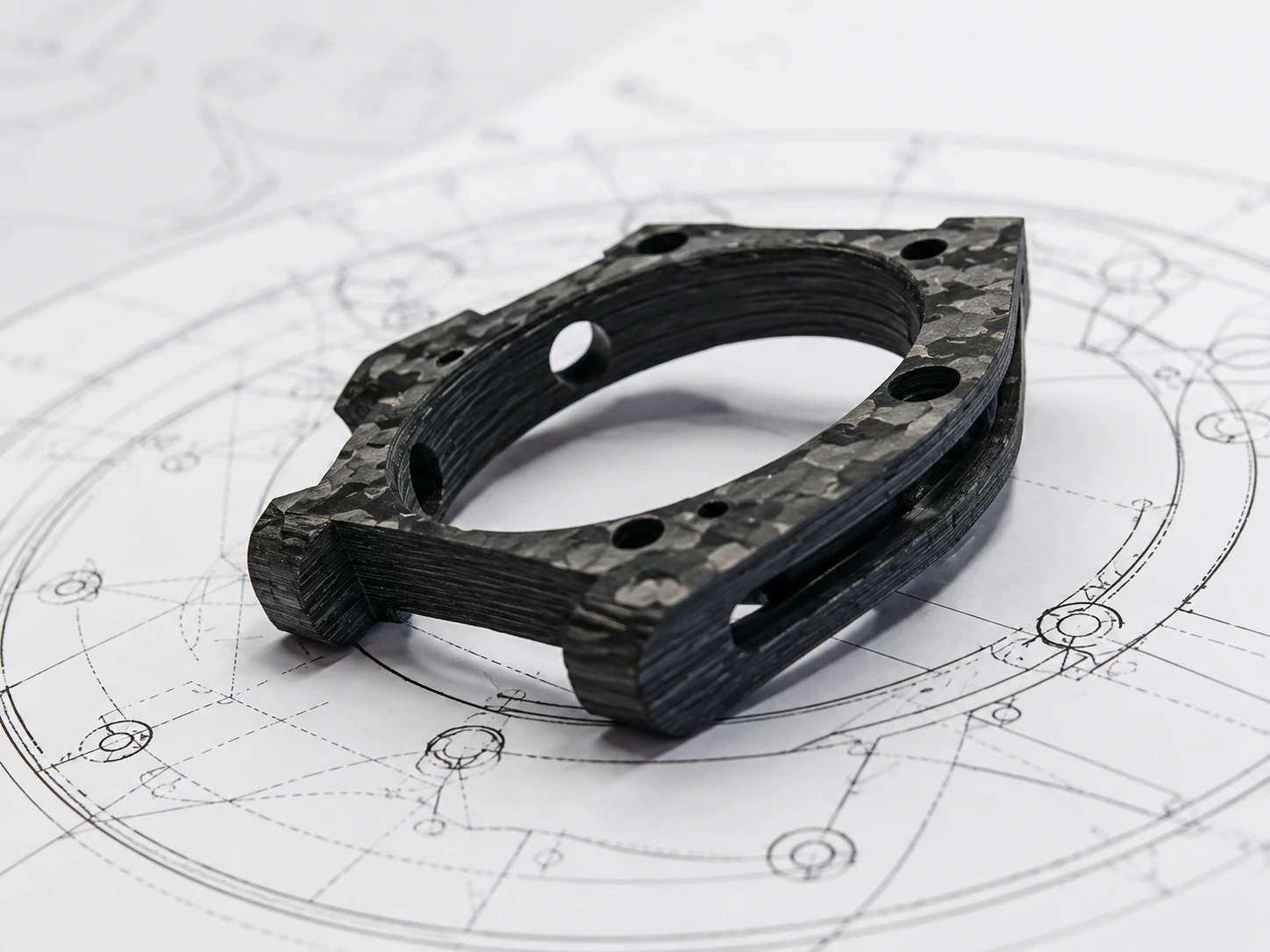 Physical carbon fiber sample reviewed with measurement and CAD inputs