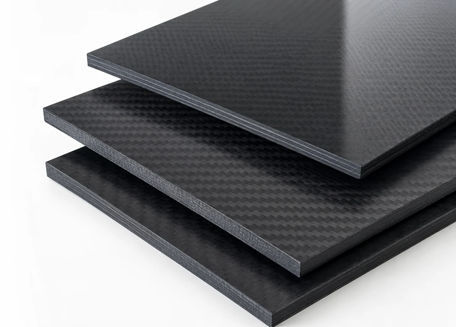 Finished solid carbon fiber panels stacked with treated edges