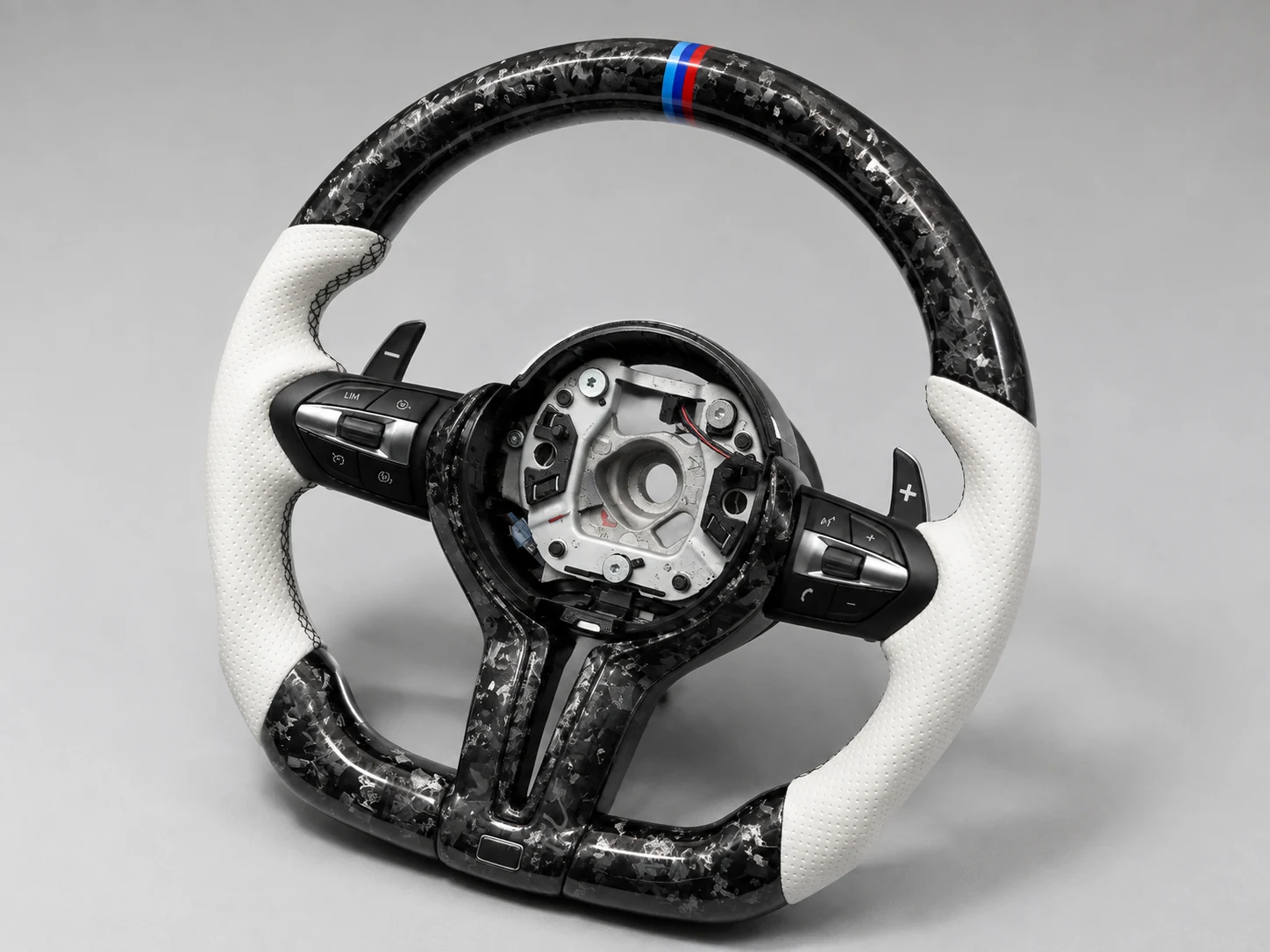 Forged carbon steering wheel with white grips and control buttons