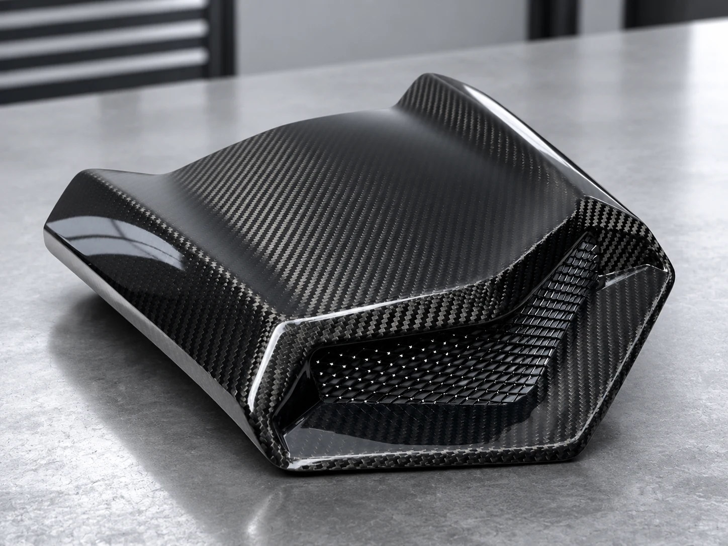 Gloss carbon fiber powersports hood with a molded intake opening